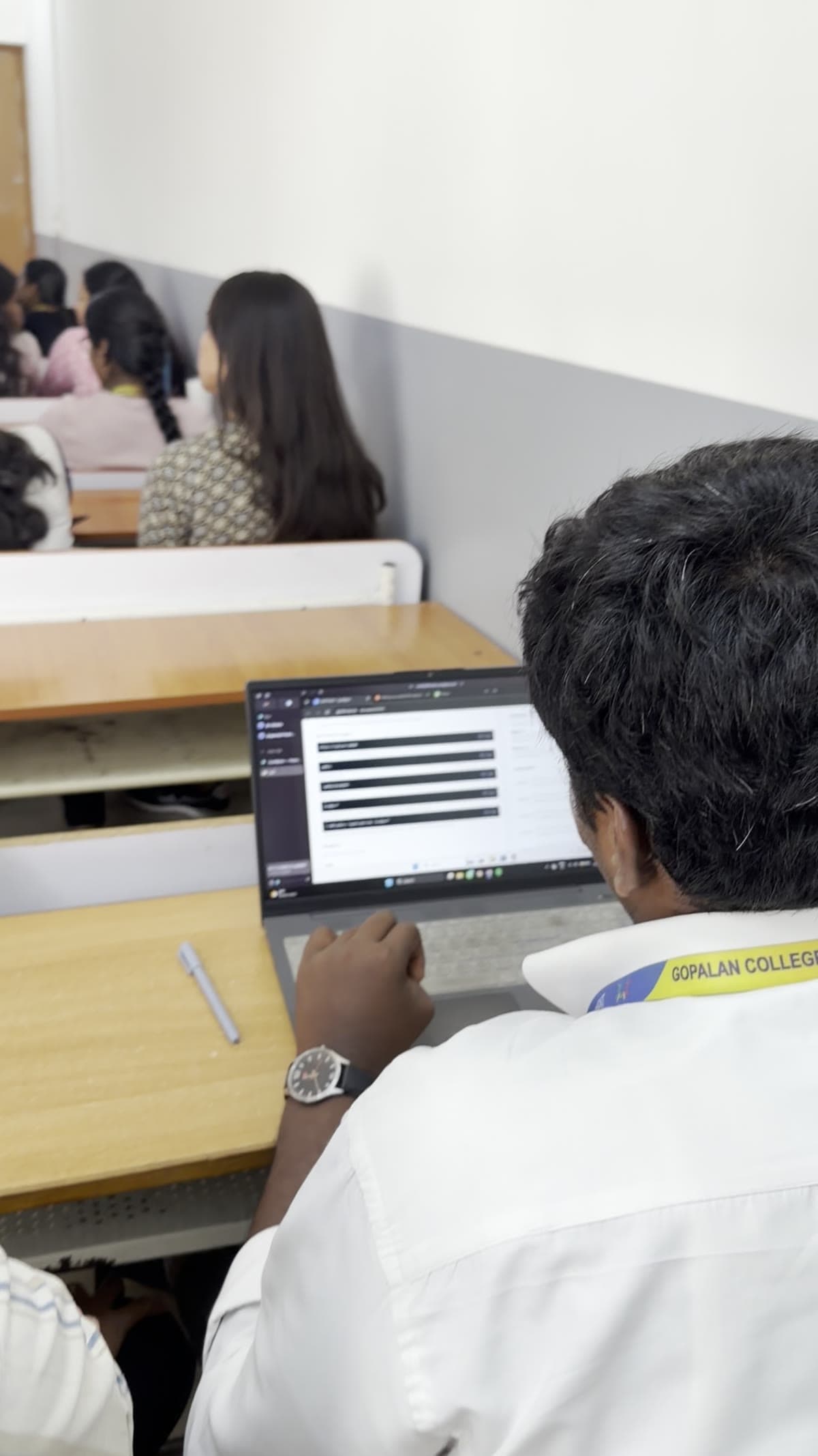 A learner working in the CymBytes lab portal with a hand at the laptop keyboard